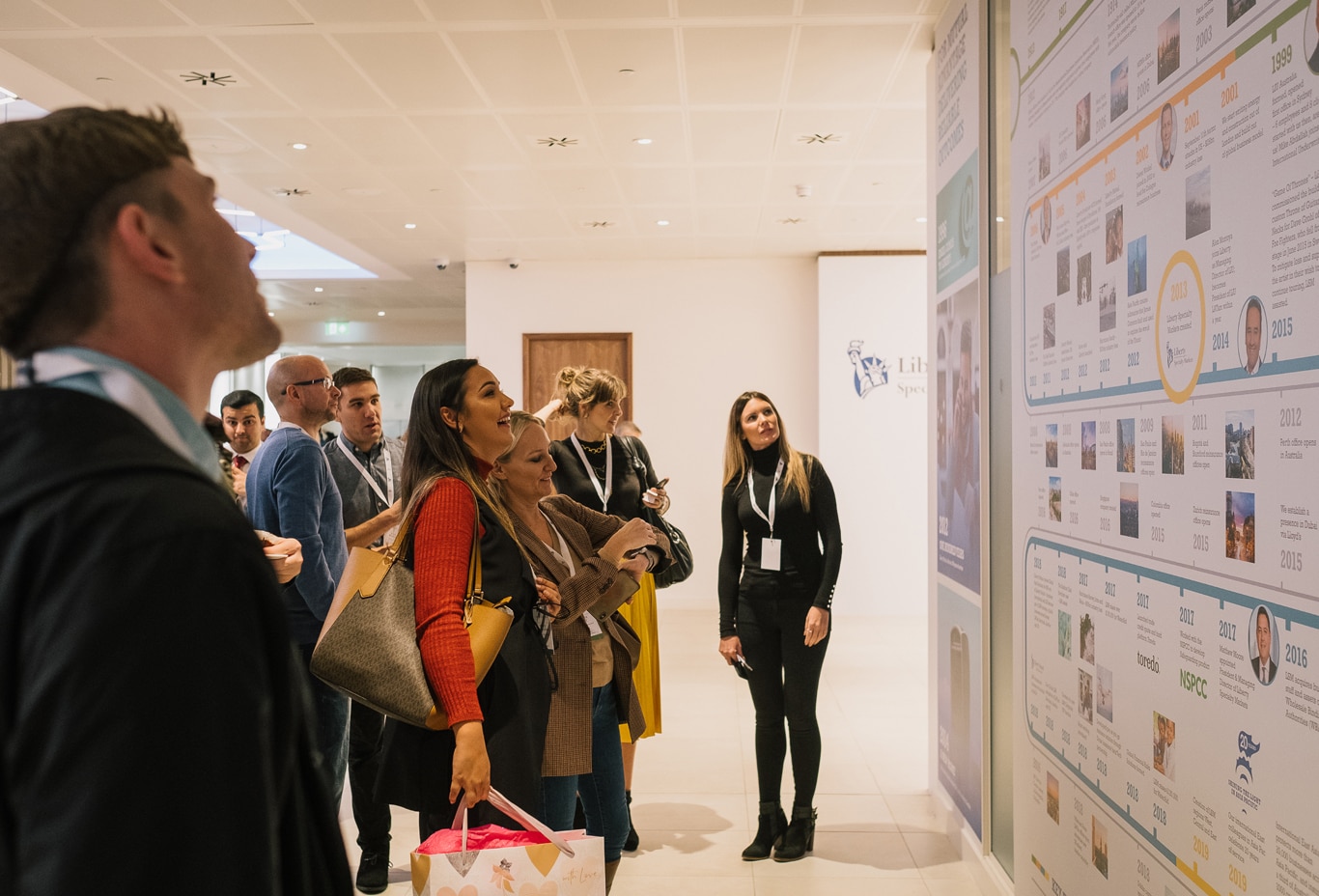 Employees reviewing the company timeline at the Liberty Specialty Markets Story Day event